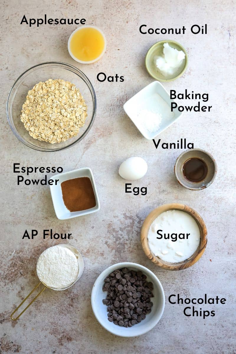 Ingredients for cookies on a grey counter in small bowls.