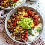 Grey bowl with taco rice in it and guac on top.