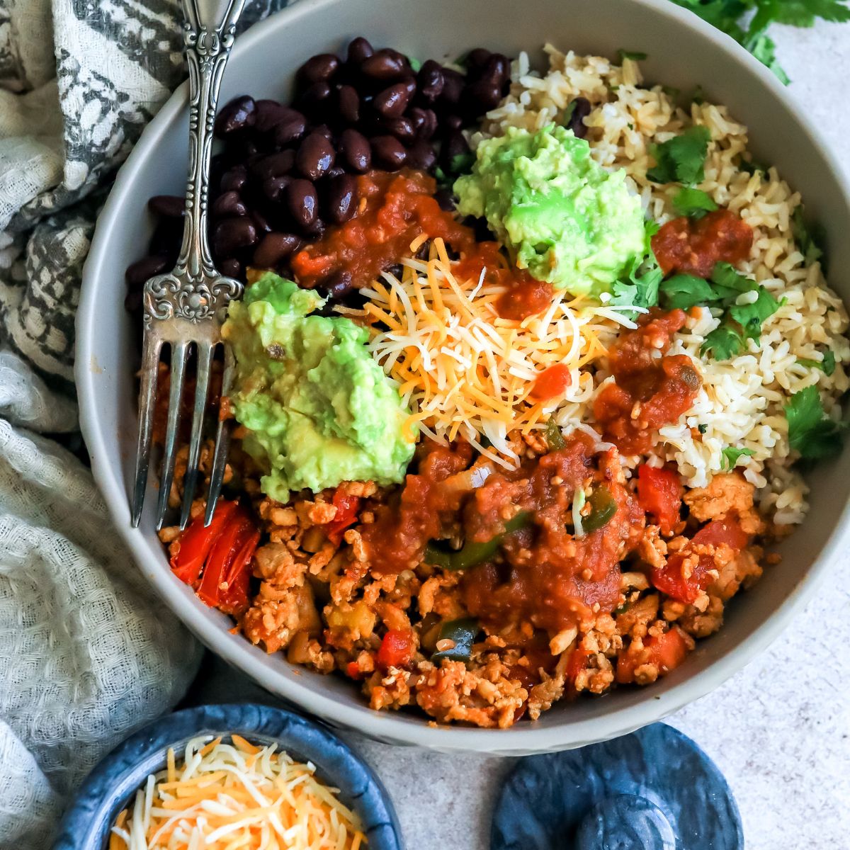 Taco rice bowl up close in big bowl with a silver fork 