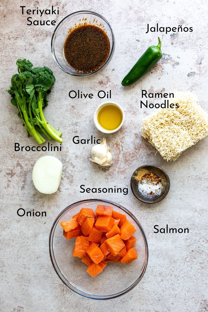 Ingredients needed to make this salmon. Everything is in bowls on a grey counter. 