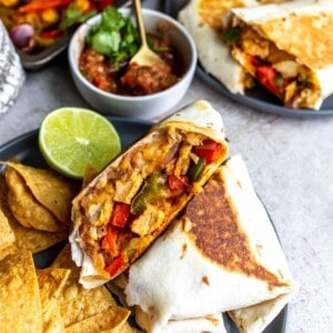 Fajita mix wrapped in a tortilla with salsa.