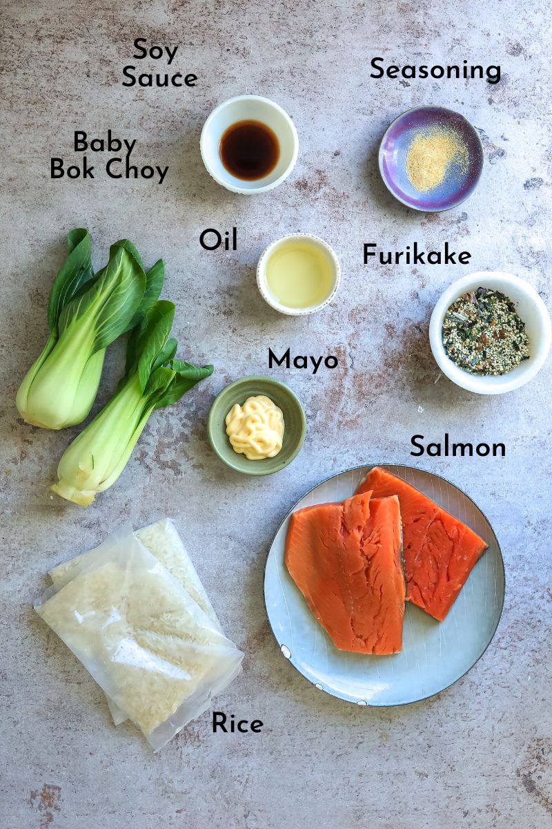 Ingredients to make Furikake salmon on a counter in small dishes. 