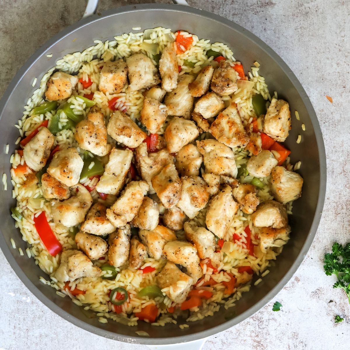 Rice and chicken in a pan with pepper. 