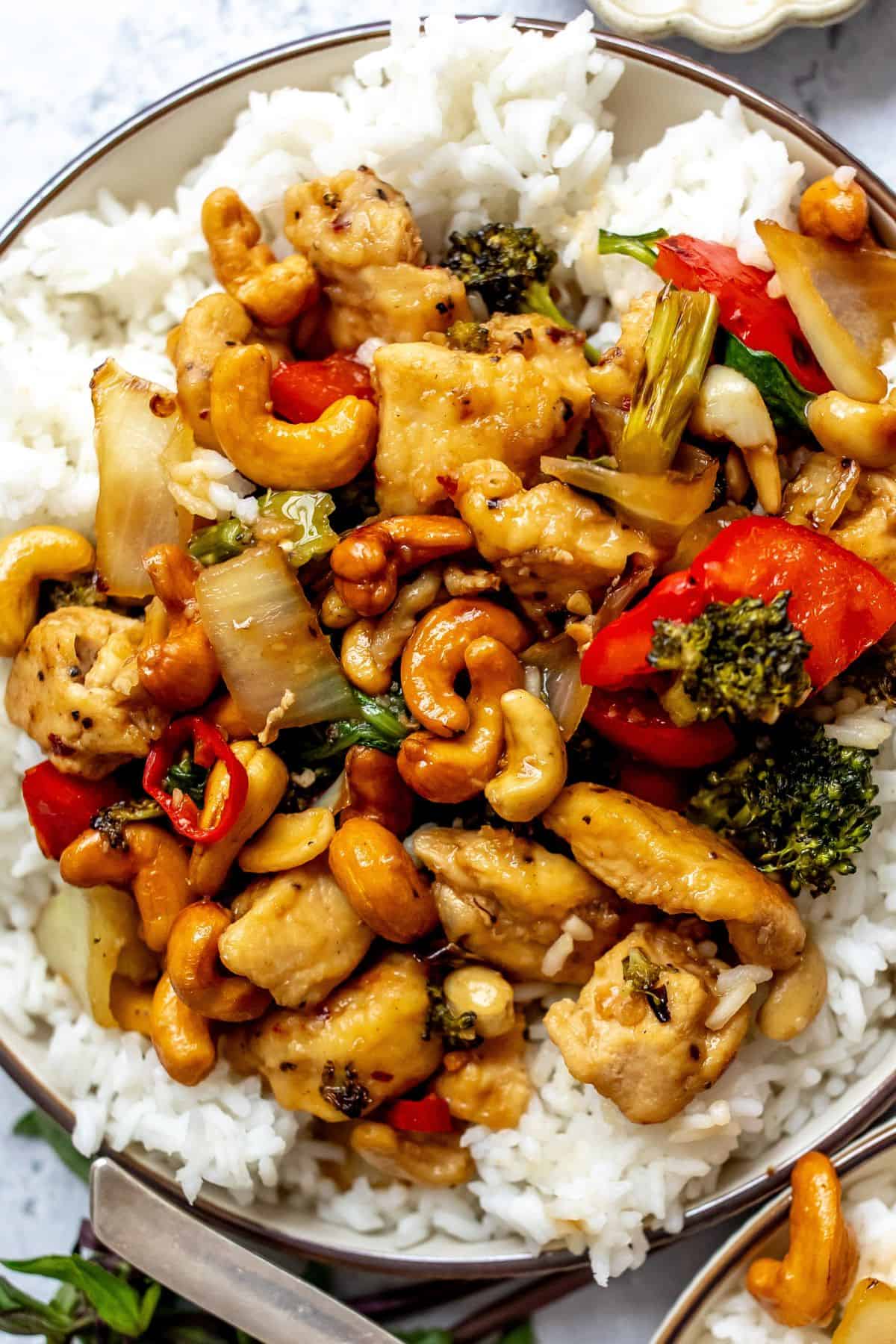 White plate with Thai Cashew Chicken over rice up close.