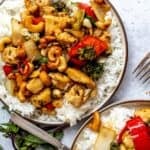 White plate with Thai Cashew Chicken over rice up close.