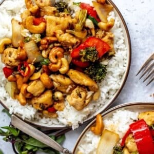 White plate with Thai Cashew Chicken over rice up close.