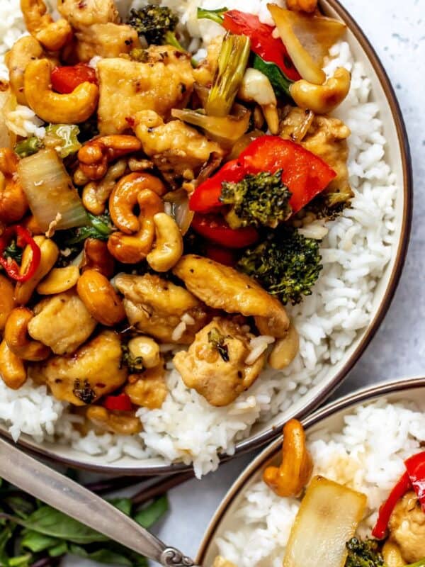 White plate with Thai Cashew Chicken over rice up close.