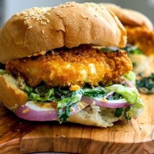 Chicken on a bun with lettuce.