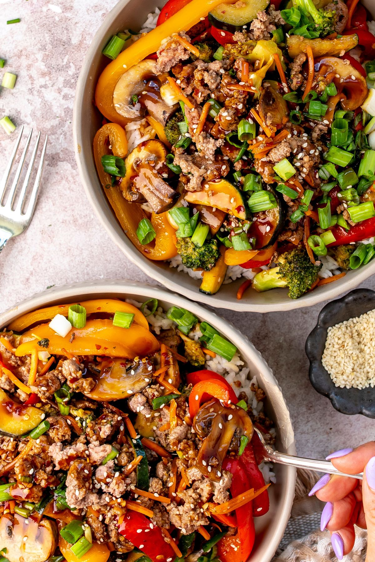 White bowl with ground beef Teriyaki over rice, up close.