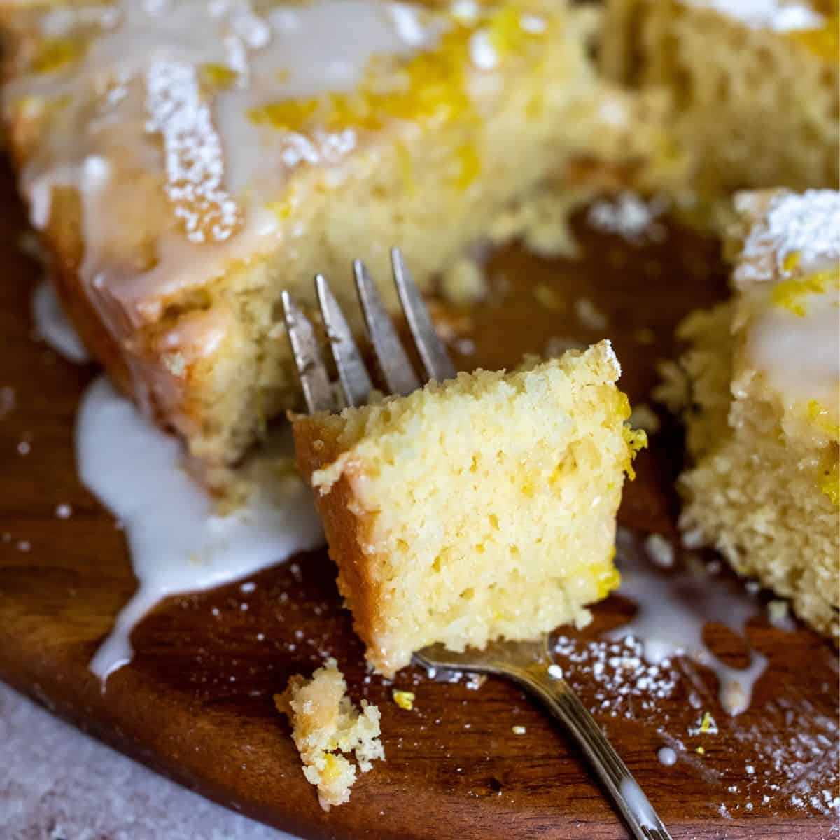 Lemon cake up close on a fork. 