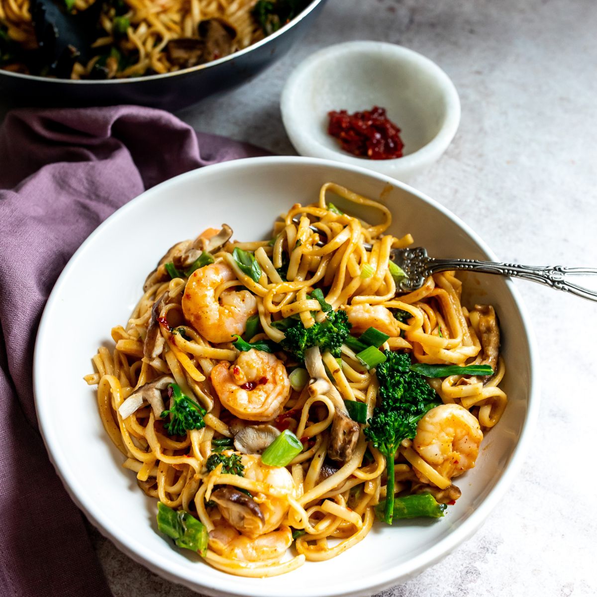 White bowl with noodles and shrimp. 