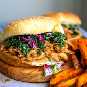 Chicken burgers up close with coleslaw and fries.