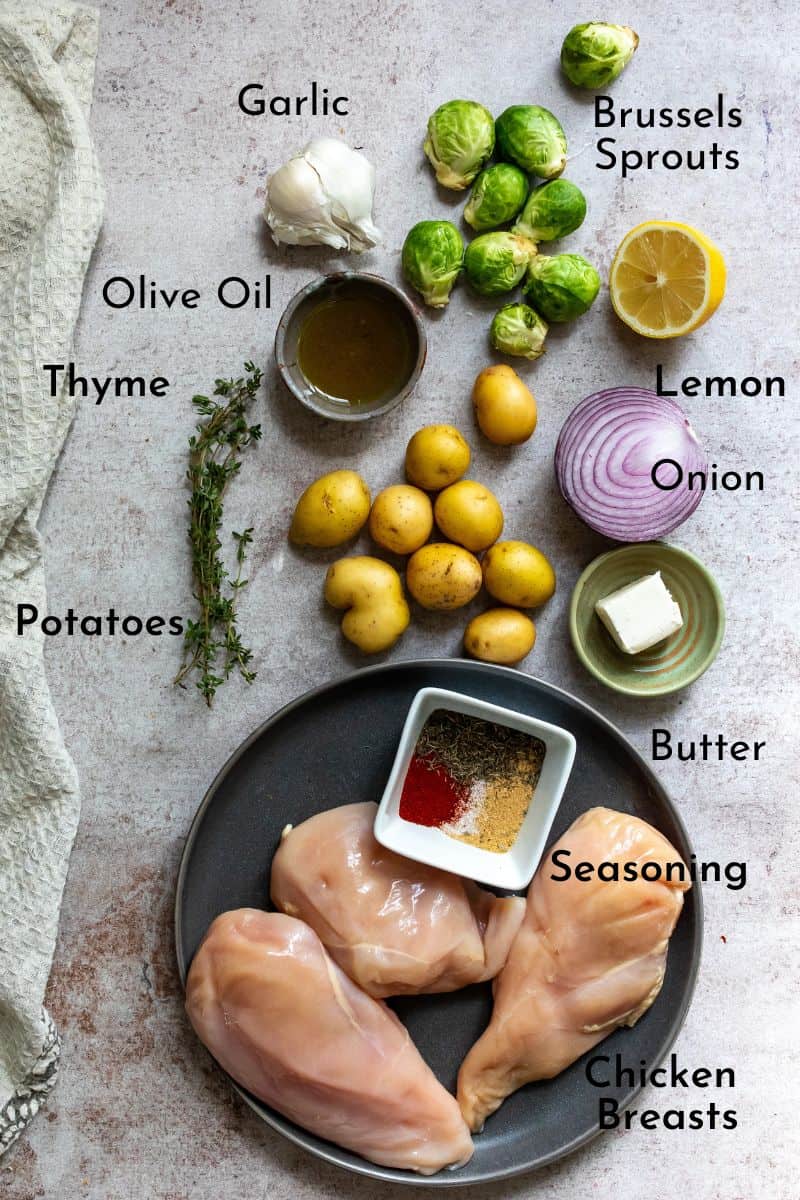 Ingredients for this chicken recipe on a counter with small bowls and a plate of chicken.