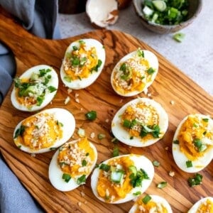 Eggs with filling on a cutting board.