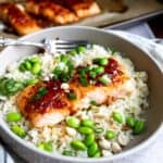 Salmon in a gray bowl with sauce.