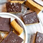 White plate with bars on them, chocolate and peanut butter.