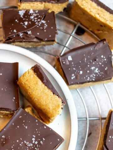 White plate with bars on them, chocolate and peanut butter.