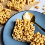 Grey plate with a spoon with peanut butter on it.