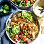 Big bowl with salad and lots of toppings.