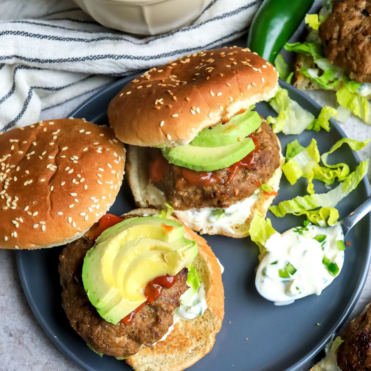 Turkey Burgers on a plate with avocado 