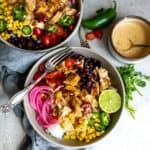 Bowls with a silver fork and chicken.
