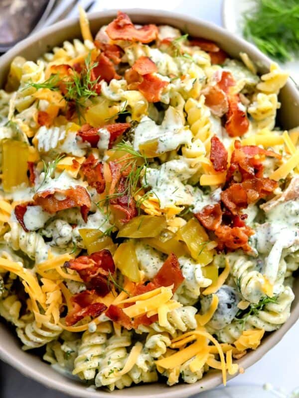 Bowl with Dill Pickle Pasta Salad in it and dill to the side.