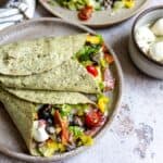 Wraps on a plate with cheese.
