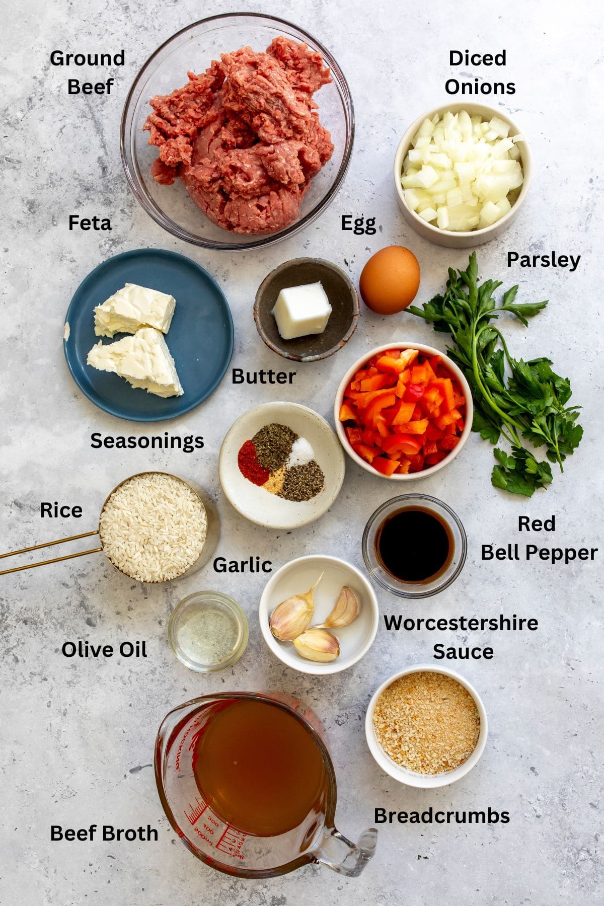 All of the ingredients for the meatballs and rice in bowls on a countertop.