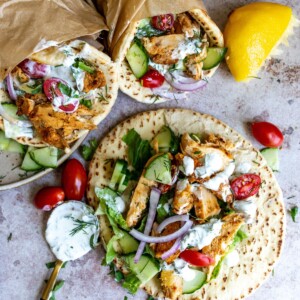 Pitas with chicken and veggies wrapped in them.