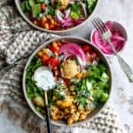 Gray bowls with spiced veggies and tzatziki sauce