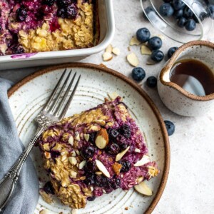 Oats on a plate with a fork and maple syrup.