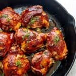BBQ baked Chicken Thighs in cast iron skillet.