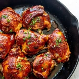 BBQ baked Chicken Thighs in cast iron skillet.