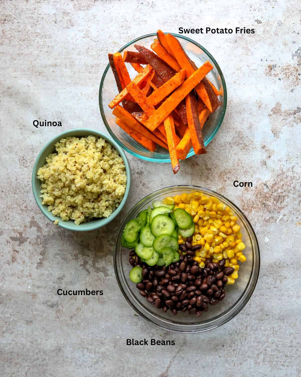 Bowls of sweet potato fries, quinoa, and corn with black beans with text labels.