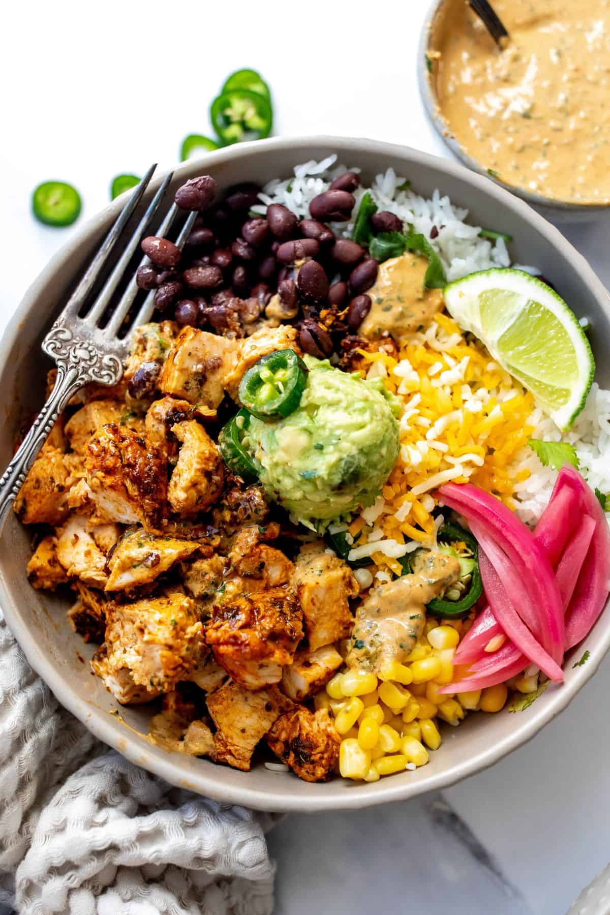 Chipotle Chicken Bowls in a grey bowl with a towel by the side. 