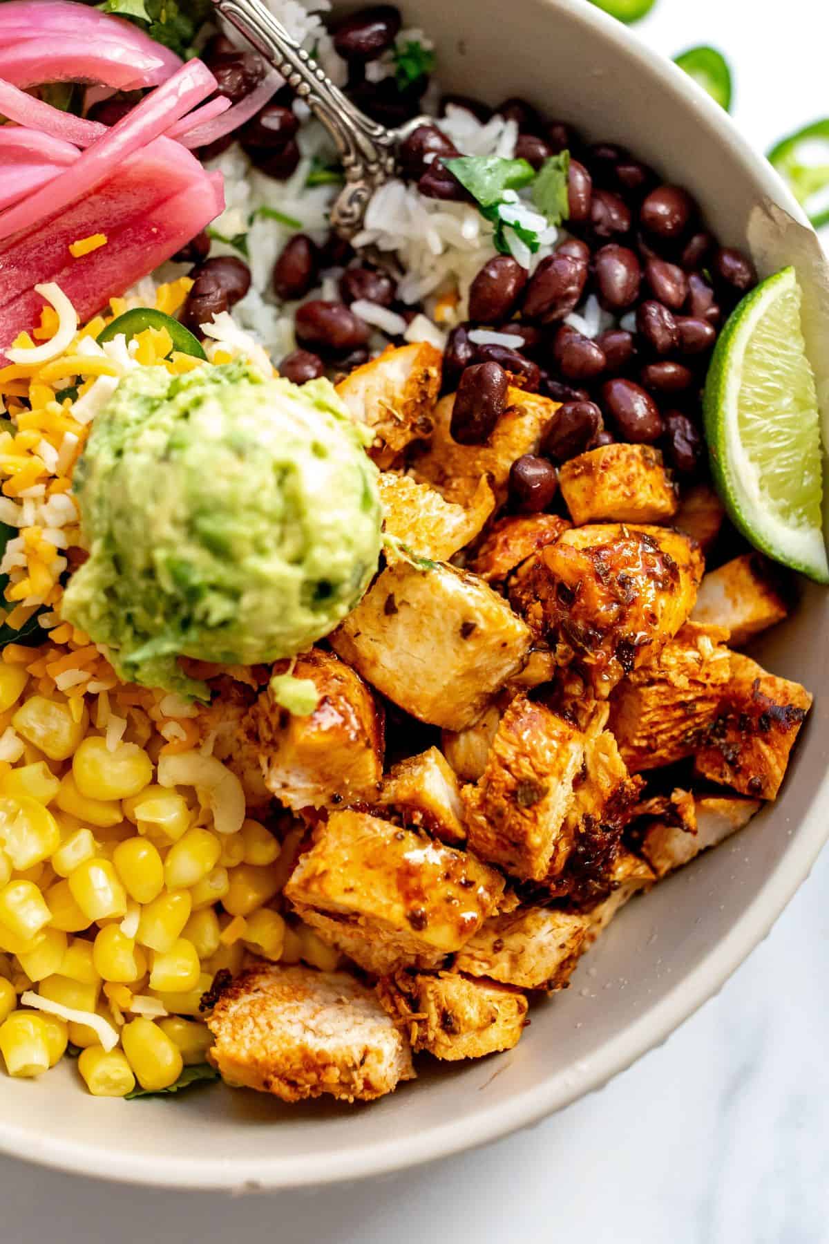 Chipotle Chicken in  a bowl up close with guacamole. 