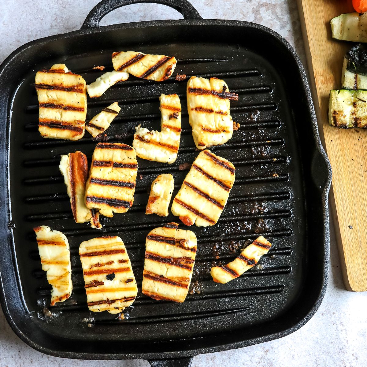 Grill pan with halloumi on it and with grill marks. 