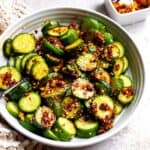 Spicy Cucumber Salad in a white ceramic bowl with spicy crunch.