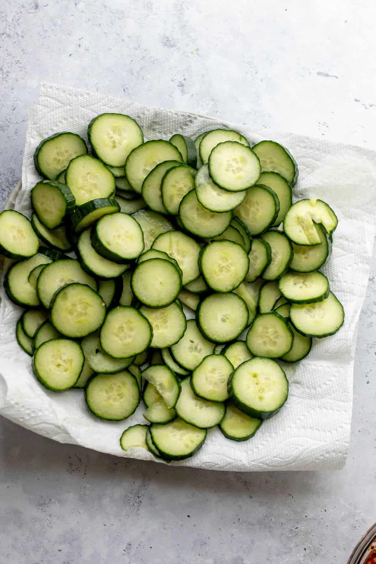 Cucumbers on a paper towel on a plate.