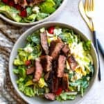 Bowl with salad, egg ad blackened steak.