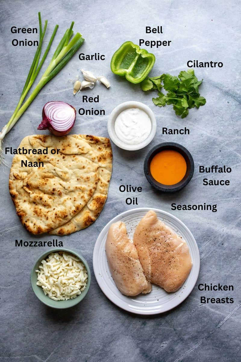 Ingredients needed on small plates and bowls on a grey counter. 