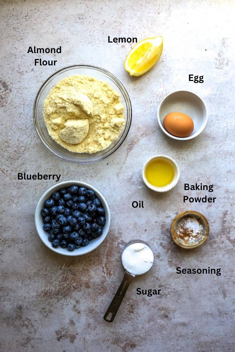 Ingredients needed to make gluten free cobbler in small bowls and measuring spoons. 