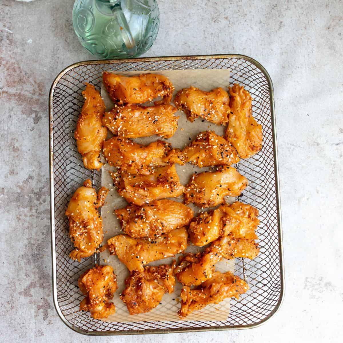 Naked Chicken Tenders on an air fryer tray 