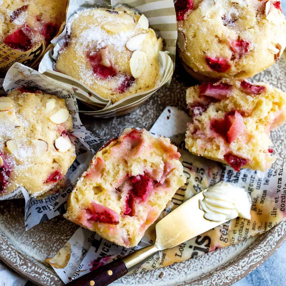 Strawberry muffins in paper holders with sugar topping.