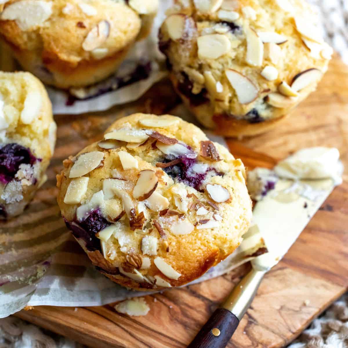 Blueberry muffins on a cutting board.
