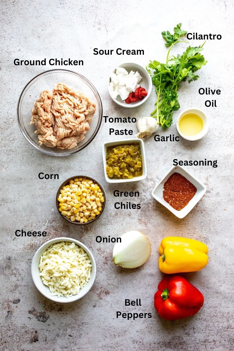 Ingredients needed to make ground turkey stuffed peppers on a counter in small bowls and plates. 
