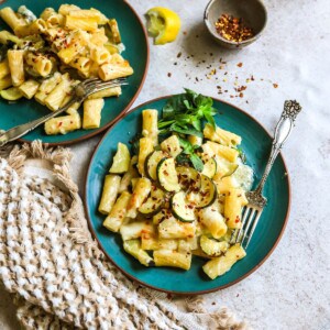 Lemon Pepper Pasta on a green plate with forks.