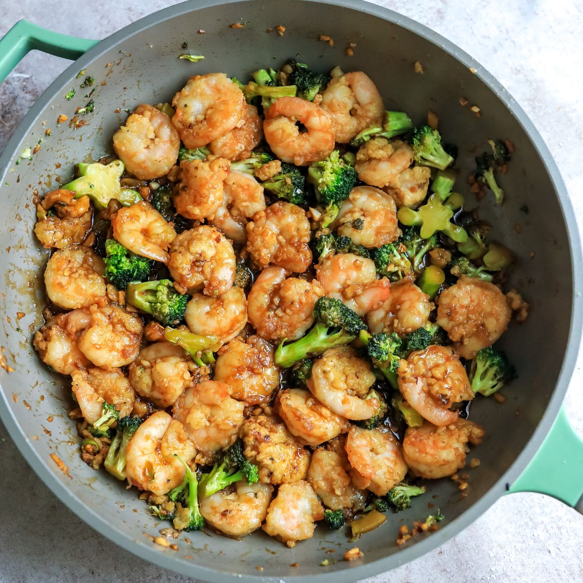 Grey skillet with Mongolian shrimp and broccoli. 
