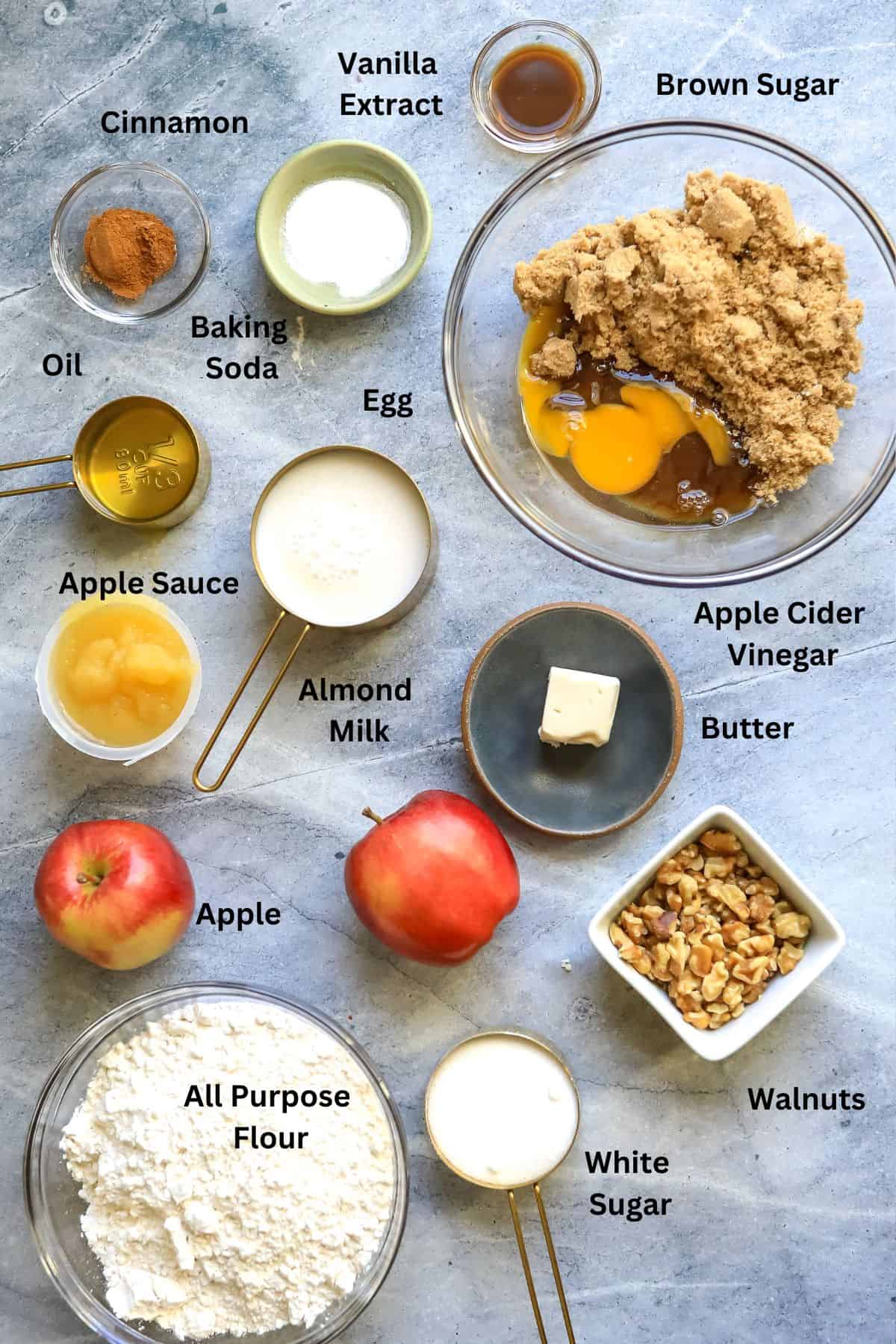 Ingredients needed to make this cake on a counter in clear mixing bowls. 