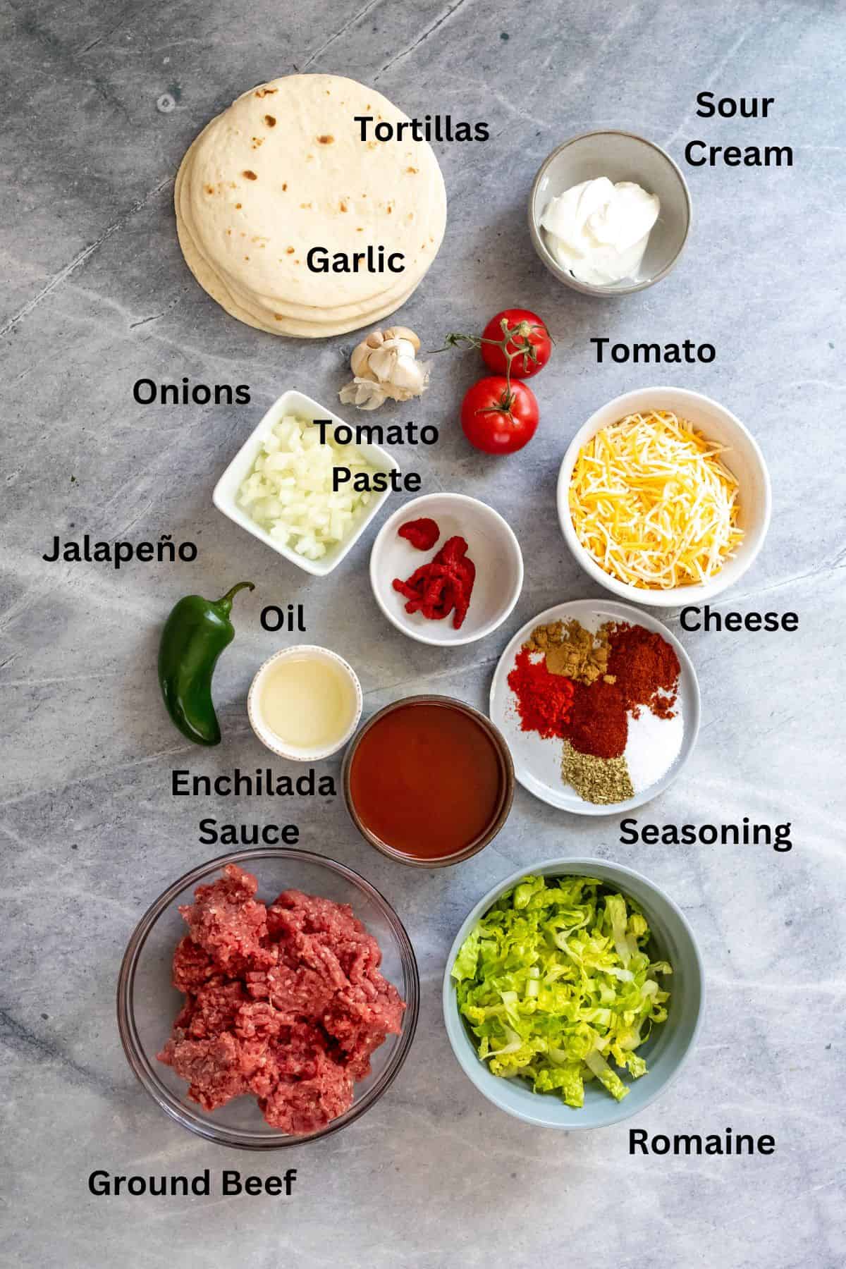 Ingredients needed to make beef soft tacos on a counter with text labels.